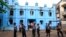 Police stand in front of a mosque and school dormitory that were damaged by a fire in Rangoon, Burma, April 2, 2013. 