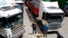 Truck drivers are seen near their parked vehicles as they await test results, amid the spread of the COVID-19 outbreak at the Namanga one-stop border crossing point between Kenya and Tanzania in Namanga, Kenya, May 12, 2020. 