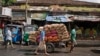 Workers pull a hand cart loaded with sacks of vegetables through a wholesale market in Colombo, Sri Lanka, Sept. 13, 2024. 