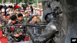 Filipinske trupe pripremaju se da polože bijele ruže na spomenik u Marawiju, podignut palim borcima u petomjesečnim bitkama protiv Islamske države, za taj grad na jugu Filipina.