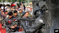 Philippine troops prepare to lay white roses at the Marawi Memorial for fellow soldiers killed in the five-month siege of Marawi city in southern Philippines by the Islamic State fighters.