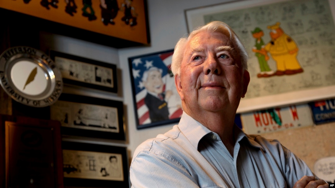 FILE - Mort Walker, the artist and author of the 'Beetle Bailey' comic strip, stands in his studio in Stamford, Conn. On, Jan. 27, 2018, a family member said Walker had died at age 94.