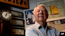 FILE - Mort Walker, the artist and author of the 'Beetle Bailey' comic strip, stands in his studio in Stamford, Conn. On, Jan. 27, 2018, a family member said Walker had died at age 94.