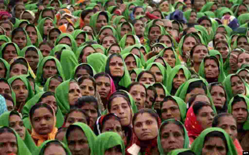 Indian women look on during Gujarat Chief Minister Narendra Modi's fast in Godhra, about 140 kilometers (87 miles) from Ahmedabad, India, Friday, Jan. 20, 2012. The fast is being held for communal harmony at Godhra town, the epicenter of 2002 riots, nearl