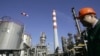 FILE - A worker is seen in the NIS Jugopetrol oil refinery, prior to a visit by Russian dignitaries, in Pancevo, Serbia, on Feb. 25, 2008.