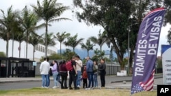 People stand outside the U.S. Embassy in Bogota, Colombia, where visa applicants were notified that appointments were canceled, Jan. 27, 2025.