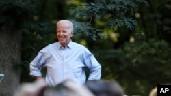 Former Vice President and Democratic presidential candidate Joe Biden arrives to speak at a house party at former Agriculture Secretary Tom Vilsack's house, July 15, 2019, in Waukee, Iowa.