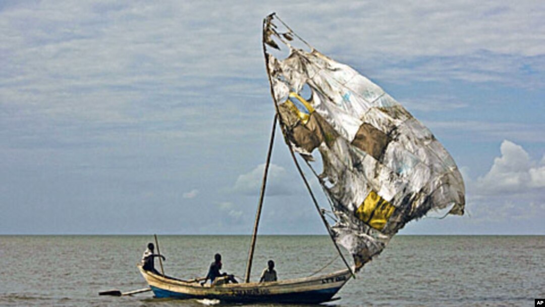 Turkana men sail their fishing boats near the shores of Lake Turkana, northeast of Kenya's capital Nairobi, August 10, 2011