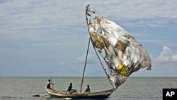 Turkana men sail their fishing boats near the shores of Lake Turkana, northeast of Kenya's capital Nairobi, August 10, 2011