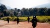 FILE - Myanmar army soldiers carrying weapons patrol on a road as part of operations against ethnic rebels, in Kokang, northeastern Shan State, more than 800 kilometers (500 miles) northeast of Yangon, Myanmar.