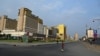 A boy in roller skates crosses a street in an area of the NagaWorld Casino buildings in Phnom Penh on March 25, 2021. (Photo by TANG CHHIN Sothy / AFP)