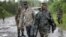 Congolese M23 rebel soldiers are seen on the road to Rushura, some 25 kilometers north of Goma, Nov. 22, 2012. 
