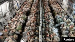 FILE - Soldiers from the Texas Army National Guard, 1-141 Infantry Battalion, are transported to Miroslawiec Air Base, Poland on a C-17 Globemaster III during exercise Swift Response 18 on June 8, 2018. (U.S. Air National Guard/Senior Airman John Linzmeier) 