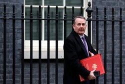 FILE - Then-British Secretary of State for International Trade Liam Fox leaving a Cabinet meeting at Downing Street in London, Jan. 15, 2019.