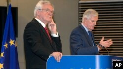 British Secretary of State for Exiting the European Union, David Davis left, and European Union chief Brexit negotiator Michel Barnier participate in a media conference at EU headquarters in Brussels, Oct. 12, 2017. 