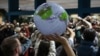 Activists hold a silent protest against the draft agreement during the COP29 U.N. Climate Change Conference in Baku, Azerbaijan, Nov. 22, 2024. 