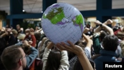 Activists hold a silent protest against the draft agreement during the COP29 U.N. Climate Change Conference in Baku, Azerbaijan, Nov. 22, 2024. 