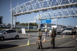 South African soldiers are seen at a checkpoint managed by the South Africa Police Services on the N1 highway in Johannesburg, April 24, 2020.