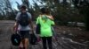 Satu keluarga berjalan setelah diselamatkan dari banjir akibat Badai Dorian, dekat Freeport, Grand Bahama, Bahamas, Selasa, 3 September 2019.