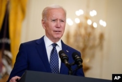 In this April 15, 2021, file photo, President Joe Biden speaks in the East Room of the White House in Washington. No nation offers asylum or other protections to people displaced because of climate change. Biden’s admin is studying the idea.