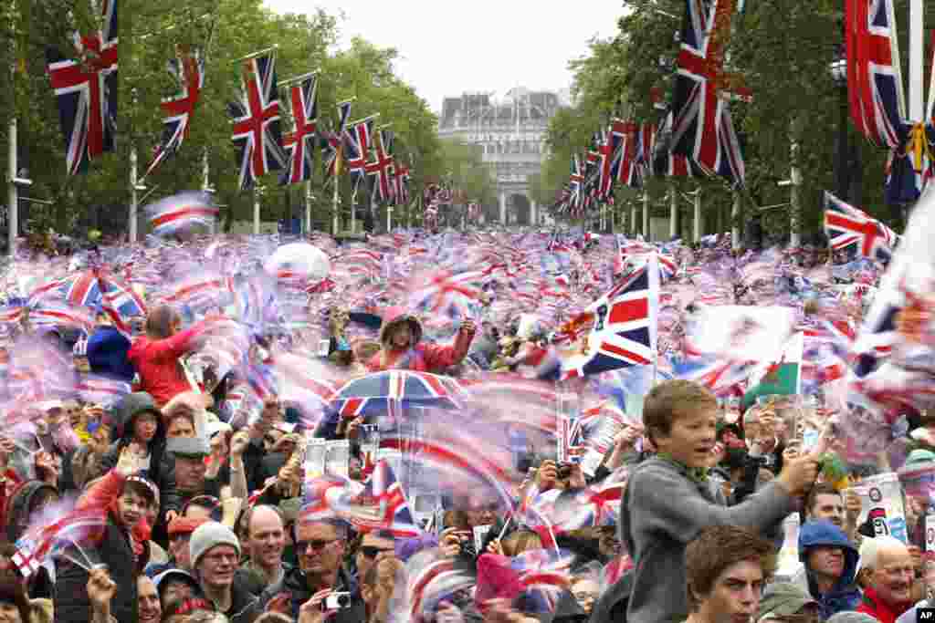 Revelers on the Mall in London watch Queen Elizabeth II appear on the Buckingham Palace balcony.