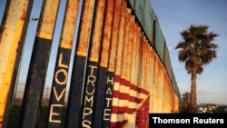 A message and the colors of the U.S. flag are seen on the U.S. and Mexico border fence at Friendship Park in Tijuana.