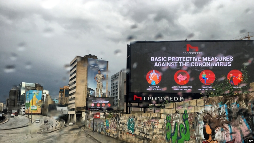 FILE - A picture taken on March 17, 2020, shows a billboard displaying protective measures against the Coronavirus in the Lebanese capital Beirut. 