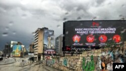 FILE - A picture taken on March 17, 2020, shows a billboard displaying protective measures against the Coronavirus in the Lebanese capital Beirut. 