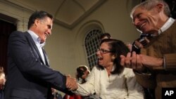 Republican presidential candidate and former Massachusetts Governor Mitt Romney greets audience members at a campaign stop in Peterborough, New Hampshire January 4, 2012, one day after winning the Iowa caucus.