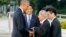 U.S. President Barack Obama, left, shakes hands and chats with Sunao Tsuboi, second right, a survivor of the 1945 atomic bombing and chairman of the Hiroshima Prefectural Confederation of A-bomb Sufferers Organization (HPCASO), as Japanese Prime Minister Shinzo Abe watches them during his visit to Hiroshima Peace Memorial Park in Hiroshima, western Japan, Friday, May 27, 2016. Obama on Friday became the first sitting U.S. president to visit the site of the world's first atomic bomb attack, bringing global attention both to survivors and to his unfulfilled vision of a world without nuclear weapons. (Kimimasa Mayama/Pool Photo via AP) 
