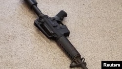 FILE: An AR-15 assault-type rifle lays on the pavement at the scene of a fatal shooting at a Waffle House restaurant, according to police officials, near Nashville, Tennessee. Taken 4.22.2018…