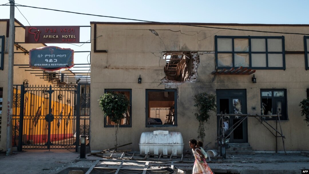 FILE - Children play in front of a hotel damaged by mortar shelling, in Humera, in the Tigray region, in Ethiopia, Nov. 22, 2020.