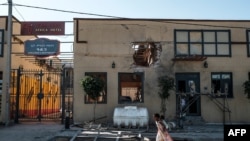 Children play in front of a hotel damaged by mortar shelling, in Humera, in the Tigray region, Ethiopia, November 22, 2020.