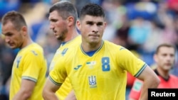 FILE - Ukraine's Ruslan Malinovskiy wears the newly introduced national team jersey emblazoned with a map of Ukraine that includes Russia-annexed Crimea, during an international friendly match against Cyprus, in Kharkiv, Ukraine, June 7, 2021.