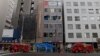 Firetrucks are seen in front of an office building, where a fire broke out in Osaka, Japan, on Dec. 17, 2021. 