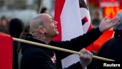 A supporter of the far-right nationalist National Democratic Party of Germany (NPD) attends a rally in Berlin April 13, 2012. Some 50 extreme-right supporters of the NPD marched on Friday through a Berlin suburb, demanding Germany dropped the Euro currenc