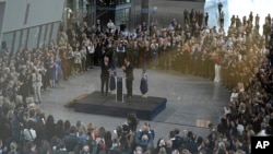 New NATO Secretary General Mark Rutte, center right, applauds his outgoing predecessor Jens Stoltenberg during a handover ceremony at NATO headquarters in Brussels, Belgium, Oct. 1, 2024.