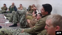A handout picture released on Jan. 13, 2016, by the news website and public relations arm of Iran's Revolutionary Guards, Sepah News, shows US sailors under detention in the Farsi Island by Iran's Revolutionary Guards after investigations showed their patrol boats had entered Iranian waters unintentionally, a statement said. 