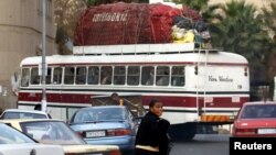 FILE: : An overloaded bus makes its way to Zimbabwe with cross-border shoppers from Johannesburg.