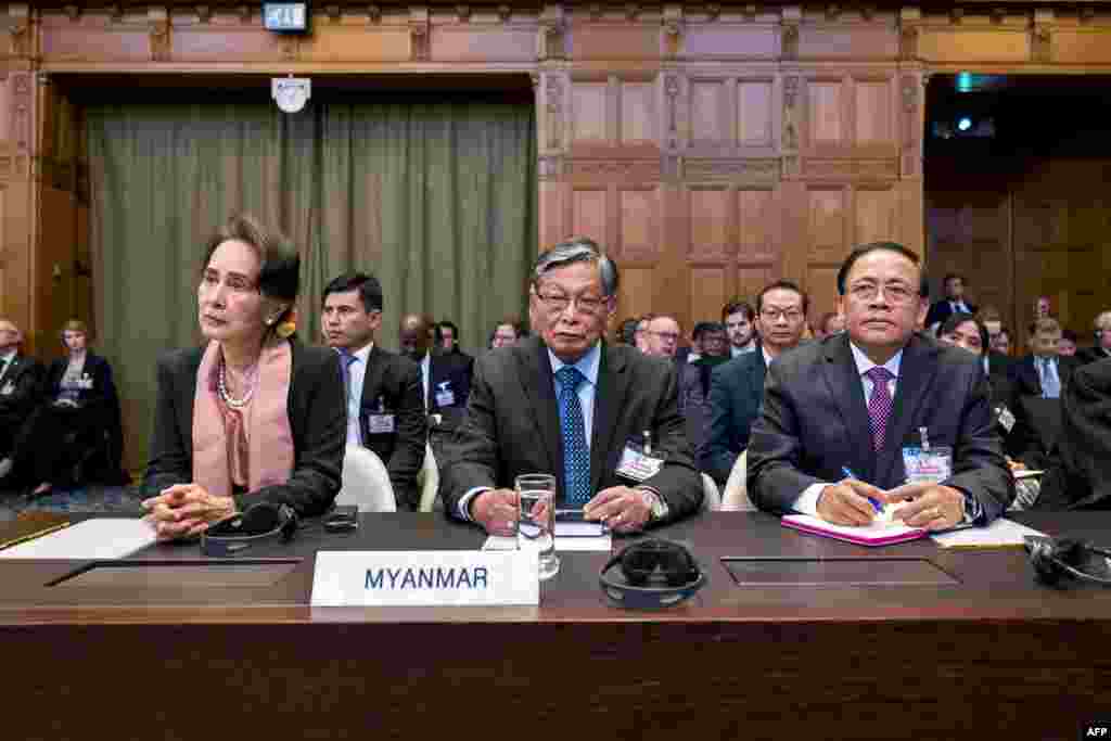 A handout photo released on December 10, 2019 by the International Court of Justice shows Myanmar&#39;s State Counsellor Aung San Suu Kyi (L) and members of the Myanmar delegation attending the start of a three-day hearing on the Rohingya genocide case before