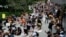 People hold up their first while taking a knee during a protest at the Martin Luther King, Jr., Memorial in Washington, June 19, 2020, while marking Juneteenth.