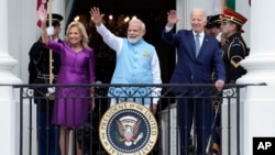 First lady Jill Biden, India's Prime Minister Narendra Modi and President Joe Biden waves from the Blue Room Balcony during an Arrival Ceremony on the South Lawn of the White House, Thursday, June 22, 2023, in Washington. (AP Photo/Manuel Balce Ceneta)