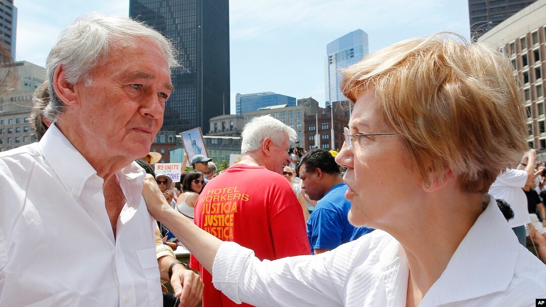 Sen. Ed Markey, D-Mass., left, talks with Sen. Elizabeth Warren, D-Mass. during the Rally Against Separation Saturday, June 30, 2018, in . (AP Photo/Winslow Townson)
