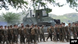 FILE - US marines prepare to board buses outside their temporary base on their way to a nearby air base as the annual US-Philippine joint military exercise winds down at the former US target range in Crow Valley, Capas town, north of Manila on May 15, 2014.