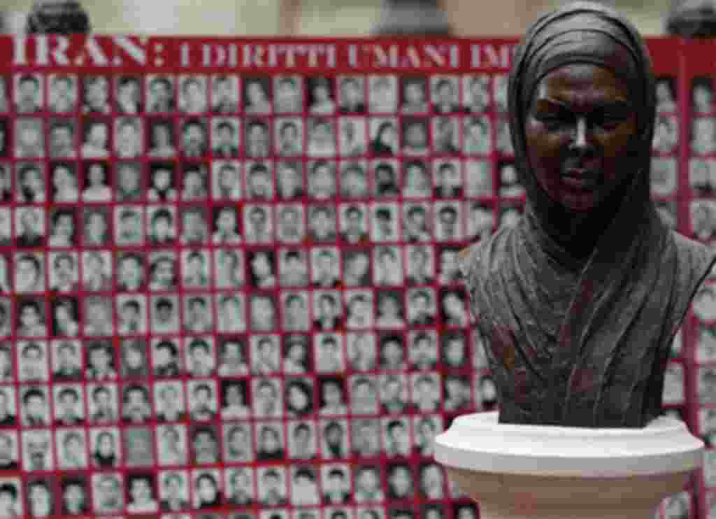 Bust of Iranian Protest Victim Neda Agha Soltan , a student killed during election protests in Tehran in 2009, is seen in front of a banner showing pictures of what Iranian opposition groups say are victims of the Iranian regime.