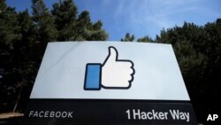 FILE - In this April 14, 2020, file photo, the thumbs up Like logo is shown on a sign at Facebook headquarters in Menlo Park, Calif. The Supreme Court has sided with Facebook in a lawsuit over unwanted text notifications it sent, rejecting a claim…