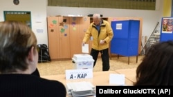 A man casts a ballot in the second round of voting for a third of the seats in Parliament’s upper house at a polling station in Otrokovice, Czech Republic, Sept. 27, 2024. (Dalibor Gluck/CTK via AP)