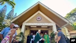 Most Rev. Clarence "Larry" Silva, the Bishop of Honolulu, greets parishioners after Mass at Sacred Hearts Mission Church in Kapalua, Hawaii, Aug. 13, 2023. The church hosted congregants from Maria Lanakila Catholic Church in Lahaina.