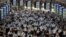 FILE PHOTO: Commuters wearing face masks arrive at Shinagawa Station at the start of the working day amid the coronavirus disease (COVID-19) outbreak, in Tokyo, Japan, August 2, 2021 .REUTERS/Kevin Coombs/File Photo