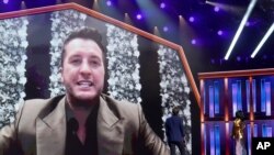 Luke Bryan appears on screen accepting the award for entertainer of the year at the 56th annual Academy of Country Music Awards on April 18, 2021, at the Grand Ole Opry in Nashville, Tenn. 